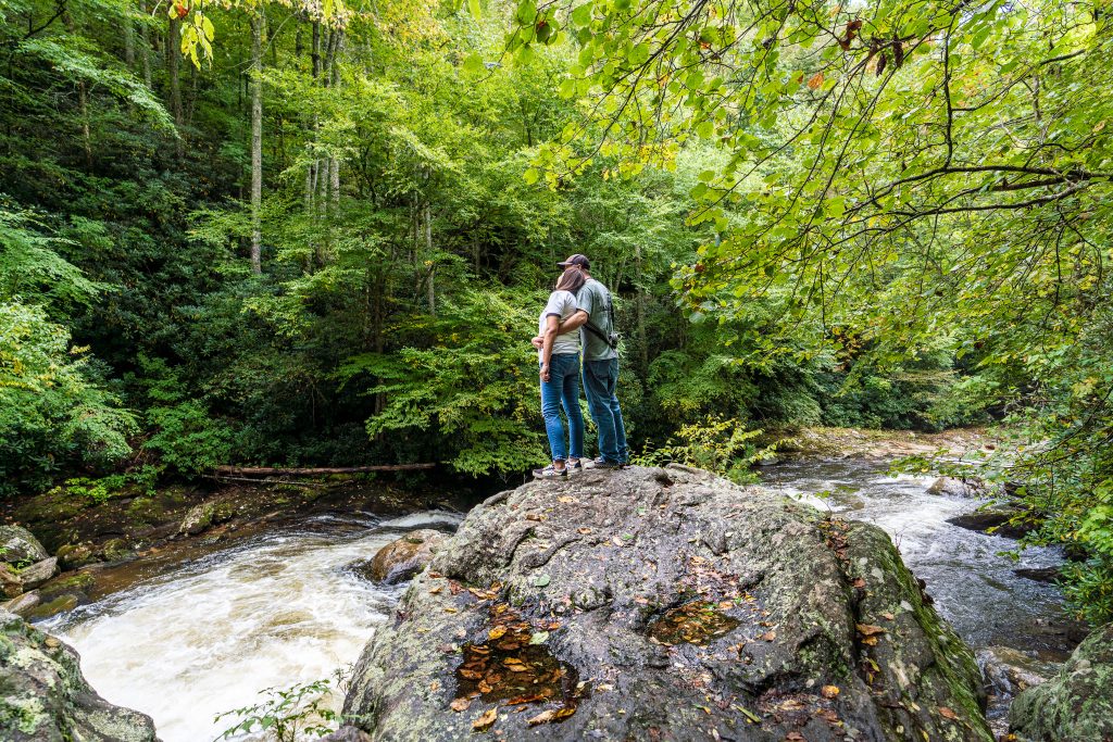 Couple looking at Cullasaja Falls' upper section in the NC Smoky Mountains